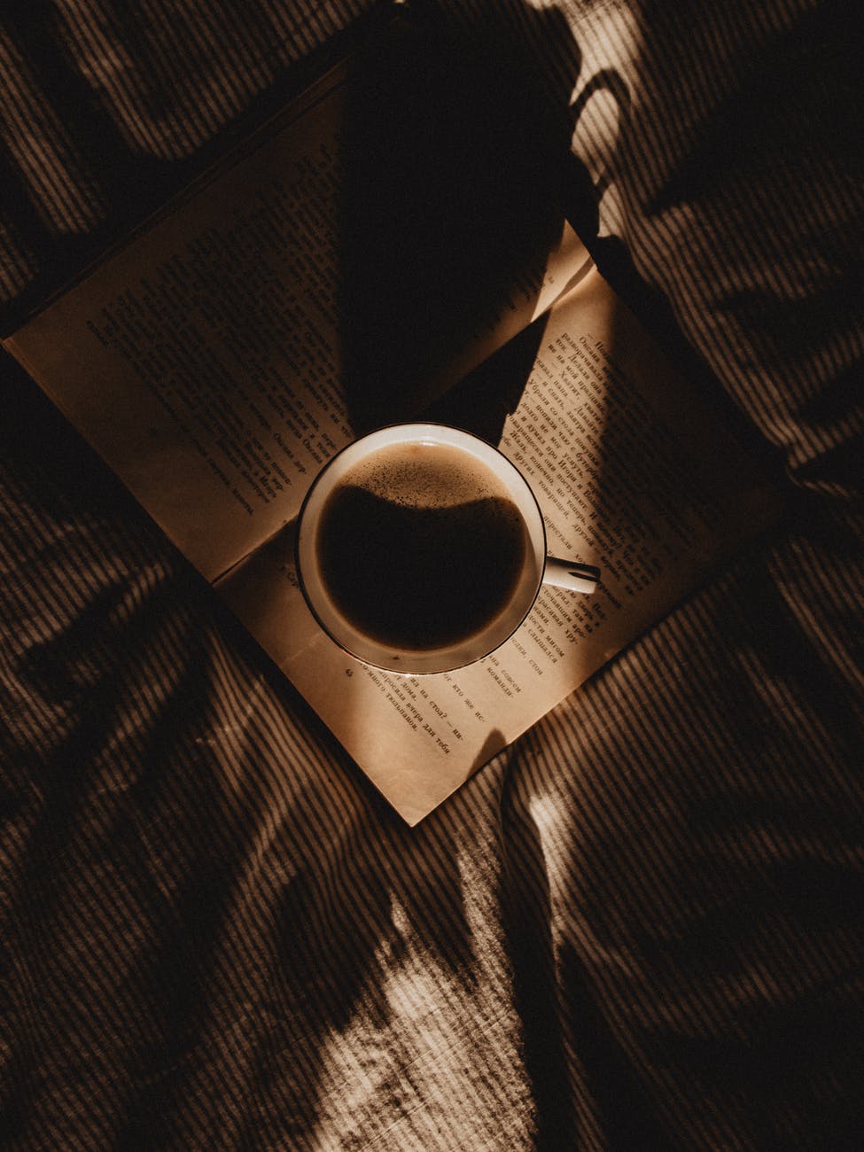 a cup of coffee on an open book